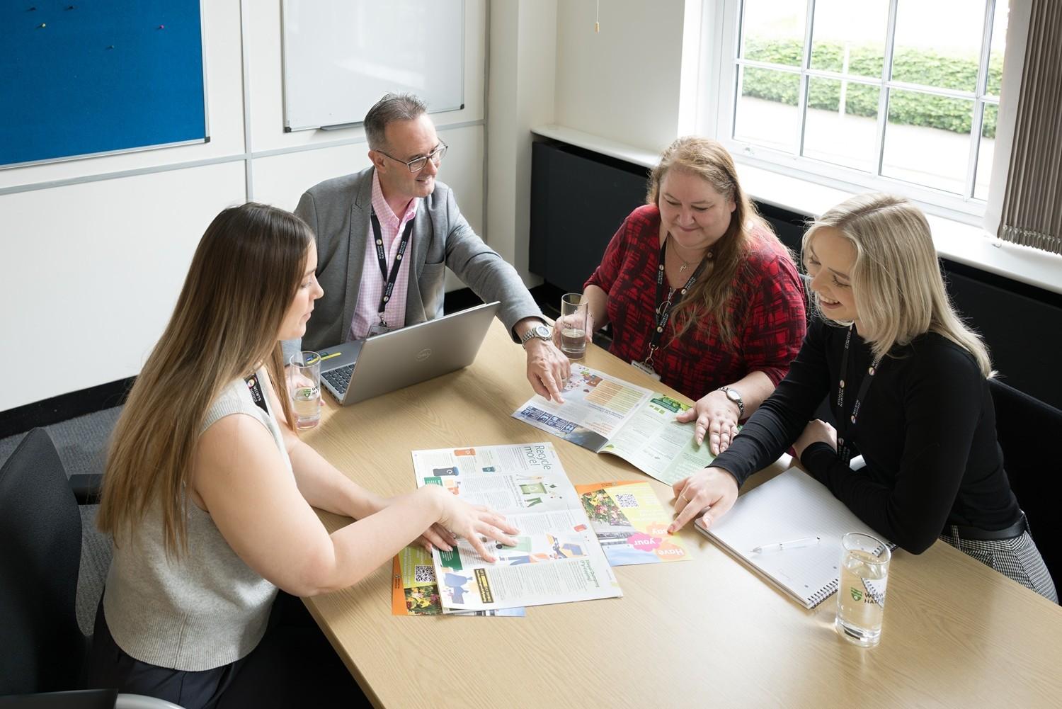 Four people sat together working in the office