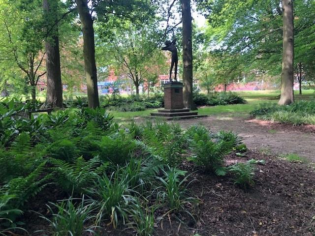 Trees and a statue in the background, somewhere in Welwyn Hatfield